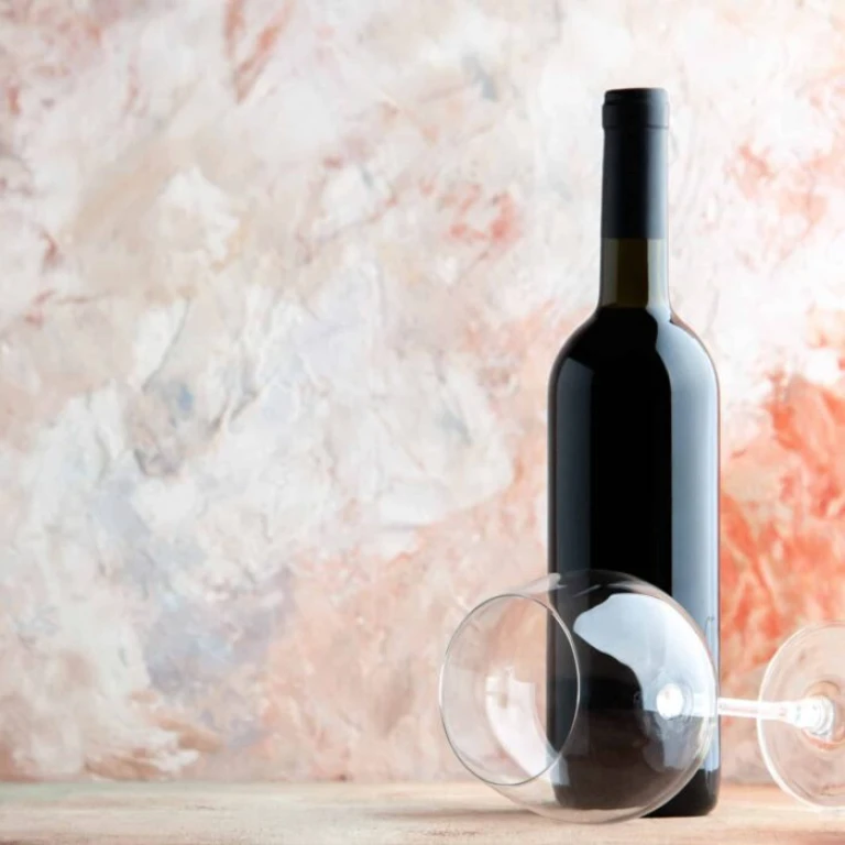 front view bottle wine with wineglass light background alcohol drink bar juice lemonade holiday dinner photo grape scaled e1723372136841 -